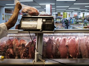 An employee sells meat during an inspection by Rio de Janeiro state's consumer protection agency, PROCON, at a supermarket in Rio de Janeiro, Brazil, on March 24, 2017.