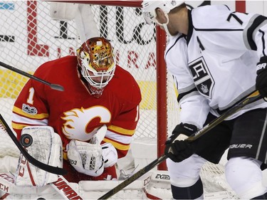 Los Angeles Kings' Jeff Carter, right, looks for a rebound as Calgary Flames goalie Brian Elliott makes a save during third period NHL action in Calgary, Alta., Sunday, March 19, 2017.