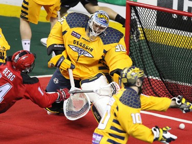 Calgary Roughnecks forward Wesley Berg scores on Georgia Swarm goaltender Mike Poulin during National Lacrosse League action at the Scotiabank Saddledome in Calgary on Saturday March 4, 2017.