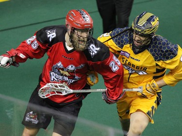 The Calgary Roughnecks' Chad Cummings and the Georgia Swarm's Miles Thompson fight for control during National Lacrosse League action at the Scotiabank Saddledome in Calgary on Saturday March 4, 2017.