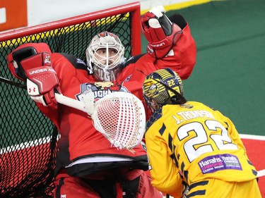 Calgary Roughnecks goaltender Frank Scigliano watches as the shot by the Georgia Swarm's Jerome Thompson is deflected during National Lacrosse League action at the Scotiabank Saddledome in Calgary on Saturday March 4, 2017.