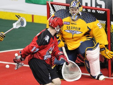 The Calgary Roughnecks' Curtis Dickson goes for a backhand shot during a scoring chance on Georgia Swarm goaltender Brodie MacDonald during National Lacrosse League action at the Scotiabank Saddledome in Calgary on Saturday March 4, 2017.