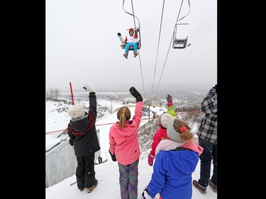 Eddie the Eagle waves to young fans as he rides a chair for another jump in Calgary. The 1988 Olympian was ski jumping in support of local jumpers at Canada Olympic Park on Saturday March 5, 2017. About a 1000 fans watched Eddie jump.