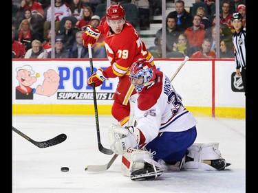 The Calgary Flames'  Micheal Ferland looks to grab a loose puck in front of Montreal Canadiens goaltender Al Montoya during NHL action at the Scotiabank Saddledome on Thursday March 9, 2017.
GAVIN YOUNG/POSTMEDIA NETWORK