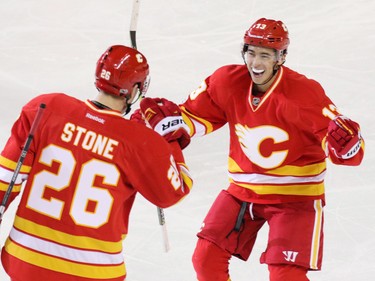 The Calgary Flames' Johnnie Gaudreau celebrates Michael Stone's goal on Montreal Canadiens goaltender Al Montoya during NHL action at the Scotiabank Saddledome on Thursday March 9, 2017. It was Stone's first goal as a Calgary Flame.
GAVIN YOUNG/POSTMEDIA NETWORK