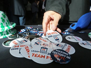 A delegate grabs a convention buttons while waiting for results to come in the PC leadership vote downtown Calgary on Saturday March 18, 2017.