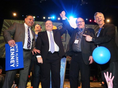 Jason Kenney raises arms with outgoing leader Ric McIver after winning the Alberta PC leadership in downtown Calgary on Saturday March 18, 2017.