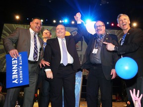 Jason Kenney raises arms with outgoing leader Ric McIver after winning the Alberta PC leadership in downtown Calgary on Saturday March 18, 2017.