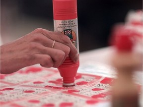 Calgary-05/19/99-A lady daubs her bingo cards at the Bingo Barn.