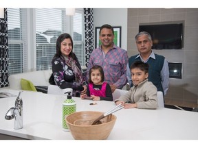 Rajeev and Rekha Babbar with their children Ansh and Aarna, along with Rajeev's father Anil Kumar, in the kitchen of  a show home by Sterling Homes in Beacon Heights.