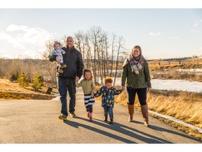 Tim and Sara Bruce. with their children Quinnley 5 years old, Weston 2.5 years old and Emmett 8 months old enjoying the eye-catching outdoor spaces in Riversong in Cochrane.