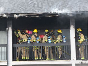 Calgary Firefighters battle a fire at a strip mall on 4500 blk of Macleod Tr S. in Calgary, Alta on Saturday March 25, 2017. Some shoppers were helped from the scene by bystanders who jumped into the blaze to raise the alarm and lead them to safety. Jim Wells//Postmedia