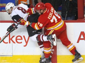 Calgary Flames Michael Ferland (R) hits Coyotes Tobias Rieder along the boards during NHL action between the Arizona Coyotes and the Calgary Flames at the Scotiabank Saddledome in Calgary, Alta. on Saturday December 31, 2016. Ferland returned to the lineup Thursday against the Nashville Predators.