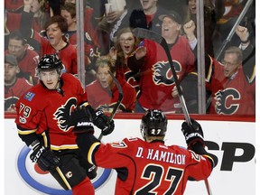 Calgary Flames forward Micheal Ferland, left, celebrates his goal against the Colorado Avalanche with teammate Dougie Hamilton at the Scotiabank Saddledome in Calgary on Monday ,March 27, 2017. (Leah Hennel)