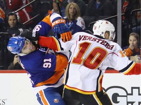 Kris Versteeg #10 of the Calgary Flames gets the gloves up on John Tavares #91 of the New York Islanders during overtime at the Barclays Center on November 28, 2016 in the Brooklyn borough of New York City. The Islanders defeated the Flames 2-1 in overtime. The two teams face each other again on Sunday in Calgary.