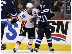 Jacob Trouba of the Winnipeg Jets fights Sam Bennett of the Calgary Flames during NHL action on March 11, 2017, at the MTS Centre in Winnipeg. (Getty Images)