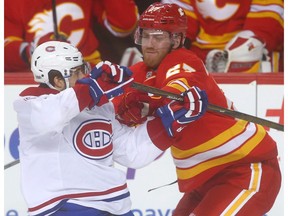 Montreal Canadiens forward Brendan Gallagher (L) battles Calgary Flames defenceman Dougie Hamilton during NHL action in Calgary on Thursday March 9, 2017 at the Scotiabank Saddledome.