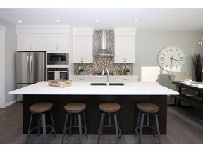 The kitchen in the Macleod show home by Cedarglen Homes in the community of Livingston.