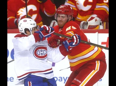 Canadiens Brendan Gallagher (L) battles Flames Dougie Hamilton during NHL action between the Montreal Canadiens and the Calgary Flames in Calgary, Alta. on Thursday March 9, 2017 at the Scotiabank Saddledome. Jim Wells/Postmedia