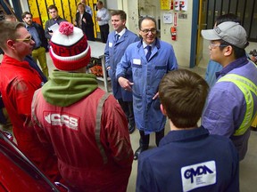 Finance Minister Joe Ceci speaks with students from Forest Lawn High School in the automotive classroom.