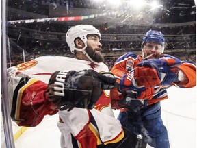 Calgary Flames' Deryk Engelland collides with Edmonton Oilers' Matt Hendricks in Edmonton on Jan. 14, 2017. (The Canadian Press)