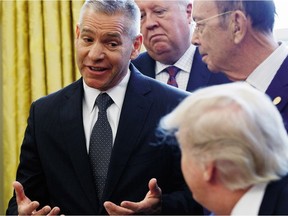 TransCanada CEO Russell K. Girling speaks to President Donald Trump in the Oval Office of the White House on Friday, March 24, 2017, during an announcement on the approval of a permit to build the Keystone XL pipeline, clearing the way for the $8 billion project.