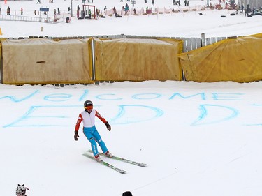 Michael Edwards best known as Eddie the Eagle skis past a welcome back Eddie sign in the snow at Canada Olympic Park on Saturday March 5, 2017. The 1988 Olympic sensation was back in Calgary to help support local jumpers. About a 1000 fans watched Eddie jump. GAVIN YOUNG/POSTMEDIA NETWORK