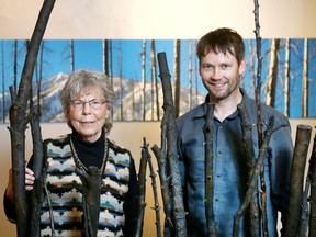 Ellis Bartkiewicz (L) and artist Brad Hays poses among an installation and new photo exhibit, Burnt Trees, at the ArtPoint Gallery on 11th Street S.E. in Calgary, Alta on Tuesday March 21, 2017. Jim Wells/Postmedia