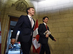 Finance Minister Bill Morneau and Prime Minister Justin Trudeau hold copies of the federal budget in Ottawa on Wednesday.