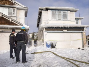 Fire and police crews work at the scene of an overnight fire on Panamount Court NW in Calgary, Alta., on Tuesday, March 7, 2017. All six occupants of the home made it out safely; the cause is under investigation.