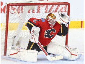 Flames goalie Brian Elliott makes a glove save in overtime NHL action between the Calgary Flames and Detroit Red Wings at the Scotiabank Saddledome in Calgary, Alta. on Friday March 3, 2017. He was named the first star and the Flames have now won six games in a row.