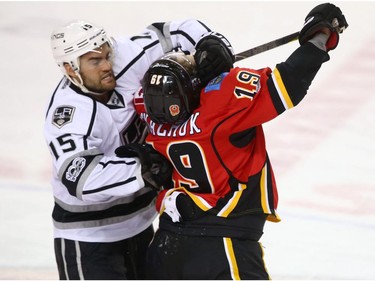 Kings Andy Andreoff and Flames Matthew Tkachuk rough it up during NHL action between the Los Angeles Kings and the Calgary Flames in Calgary, Alta. on Wednesday March 29, 2017. There were a number of penalties on the play including a misconduct. Jim Wells/Postmedia