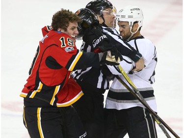 Kings Andy Andreoff and Flames Matthew Tkachuk rough it up during NHL action between the Los Angeles Kings and the Calgary Flames in Calgary, Alta. on Wednesday March 29, 2017. There were a number of penalties on the play including a misconduct. Jim Wells/Postmedia