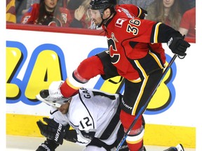 Los Angeles Kings' Marian Gaborik ducks a blow from Calgary Flames' Troy Brouwer in Calgary on Wednesday, March 29, 2017. (Jim Wells)