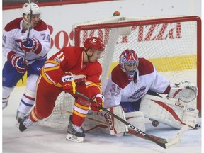 Flames Mikael Backlund (C) drives to the net in front of Canadiens goalie Al Montoya during NHL action between the Montreal Canadiens and the Calgary Flames in Calgary, Alta. on Thursday March 9, 2017 at the Scotiabank Saddledome.