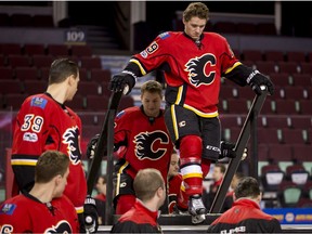 Matthew Tkachuk of the Calgary Flames walks carefully onto a raised platform for team photo at the Scotiabank Saddledome in Calgary on Tuesday, March 28, 2017. (Lyle Aspinall)