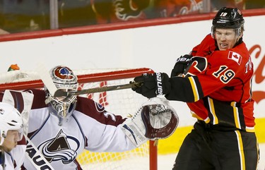Matthew Tkachuk of the Calgary Flames tries to hit a puck in front of Colorado Avalanche goalie Calvin Pickard during NHL action in Calgary, Alta., on Monday, March 27, 2017. The Flames won 4-2. Lyle Aspinall/Postmedia Network