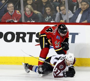 Calgary Flames Matt Bartkowski, left, collides with Colorado Avalanche J.T. Compher during their game at the Scotiabank Saddledome in Calgary, Alta., on Monday March 27, 2017. Leah Hennel/Postmedia