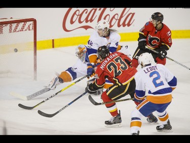 Sean Monahan of the Calgary Flames scores after a pass from teammate Johnny Gaudreau near Nick Leddy, Scott Mayfield and goalie Thomas Greiss of the New York Islanders during NHL action in Calgary, Alta., on Sunday, March 5, 2017. The Flames were gunning for their seventh straight win. Lyle Aspinall/Postmedia Network