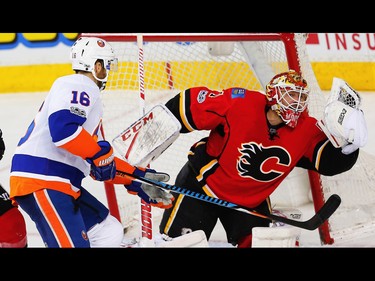 Calgary Flames Brian Elliott makes a save on a shot by Andrew Ladd of the New York Islanders during NHL hockey in Calgary, Alta., on Sunday, March 5, 2017. AL CHAREST/POSTMEDIA