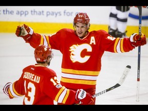 Sean Monahan of the Calgary Flames celebrates scoring the game's first goal with teammate Johnny Gaudreau on Sunday, March 19, 2017.