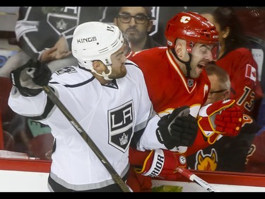 Andy Andreoff of the Los Angeles Kings collides with Mark Giordano of the Calgary Flames during NHL action in Calgary, Alta., on Sunday, March 19, 2017. Lyle Aspinall/Postmedia Network