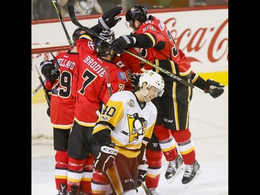 The Calgary Flames celebrate Matt Stajan's first-period goal near Oskar Sundqvist of the Pittsburgh Penguins during NHL action in Calgary, Alta., on Monday, March 13, 2017. The Flames were gunning for their 10th-straight win, which would set a new franchise record. Lyle Aspinall/Postmedia Network