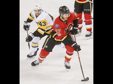 Dougie Hamilton of the Calgary Flames skates away from Conor Sheary of the Pittsburgh Penguins during NHL action in Calgary, Alta., on Monday, March 13, 2017. The Flames were gunning for their 10th-straight win, which would set a new franchise record. Lyle Aspinall/Postmedia Network