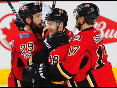 Calgary Flames Matt Stajan celebrates with teammates Deryk Engelland and Lance Bouma after scoring on Marc-Andre Fleuryof the Pittsburgh Penguins during NHL hockey in Calgary, Alta., on Monday, March 13, 2017. AL CHAREST/POSTMEDIA