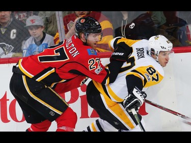 Calgary Flames Dougie Hamilton and Sidney Crosby of the Pittsburgh Penguins during NHL hockey in Calgary, Alta., on Monday, March 13, 2017. AL CHAREST/POSTMEDIA