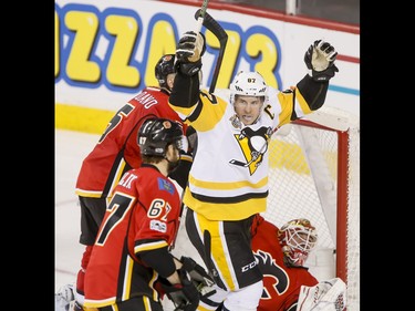 Sidney Crosby of the Pittsburgh Penguins celebrates his third-period game-tying goal on Calgary Flames goalie Brian Elliott and near Mark Giordano and Michael Frolik during NHL action in Calgary, Alta., on Monday, March 13, 2017. The Flames won 4-3 in a shootout, marking their 10th-straight win and setting a new franchise record. Lyle Aspinall/Postmedia Network