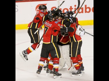 The Calgary Flames celebrate their shootout win over the Pittsburgh Penguins during NHL action in Calgary, Alta., on Monday, March 13, 2017. The Flames won 4-3 in a shootout, marking their 10th-straight win and setting a new franchise record. Lyle Aspinall/Postmedia Network