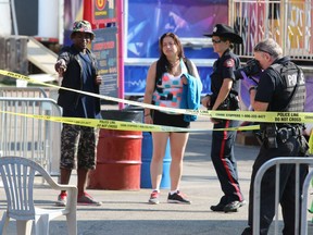 Police investigate the scene of an a stabbing on the Calgary Stampede Midway.