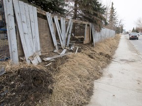 A smashed-out fence sits alongside northbound Edmonton Trail at 27 Ave. N.E. after an alleged hit-and-run in Calgary on Wednesday, March 29, 2017. Lyle Aspinall/Postmedia Network